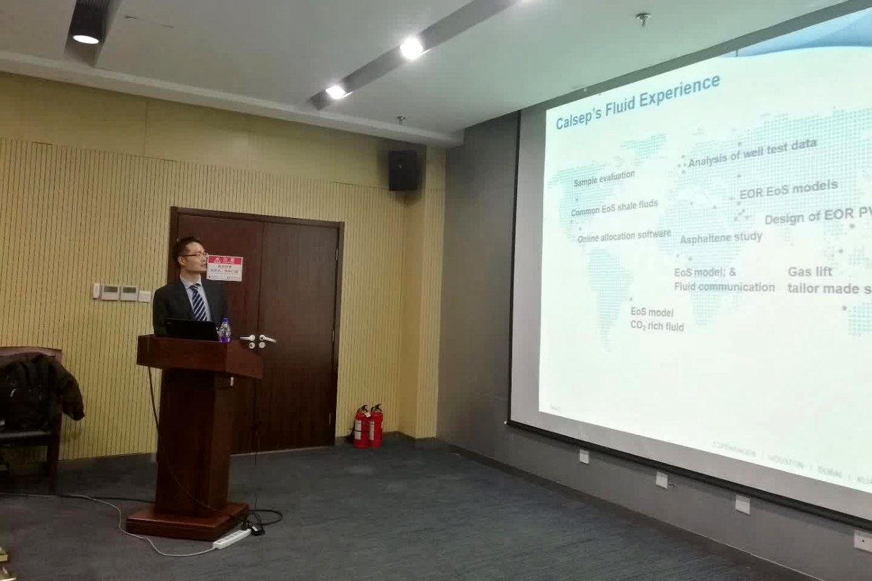 投影屏幕显示 Calsep's Fluid Experience 页面，世界地图上分布着各类流体研究方向